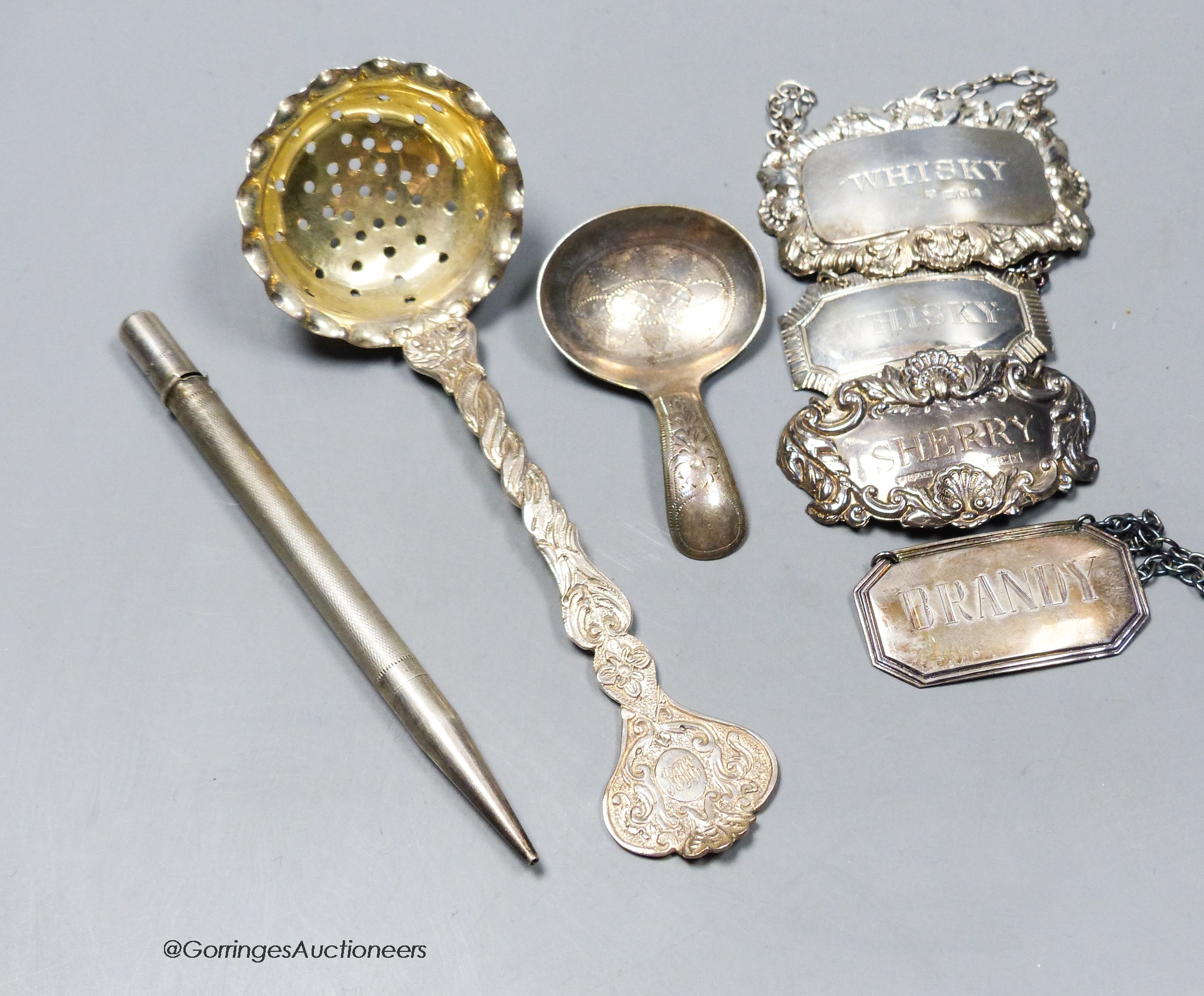Four modern silver wine labels, caddy spoon, silver spoon and pencil.